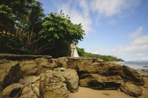 bride-groom-beach-rocks-kissing